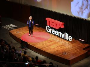 professor on stage giving a Ted talk