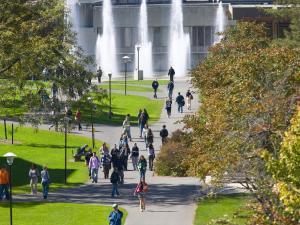 People walking on Quad with fountains.