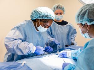 student performing a procedure in operating room