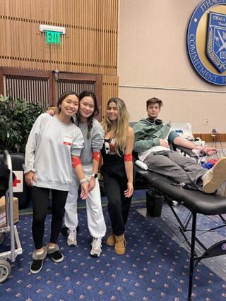 Mel is posing in a group photo with some other students at Ithaca College blood drive.