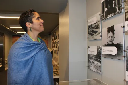 President Collado looking at image of Ithaca College