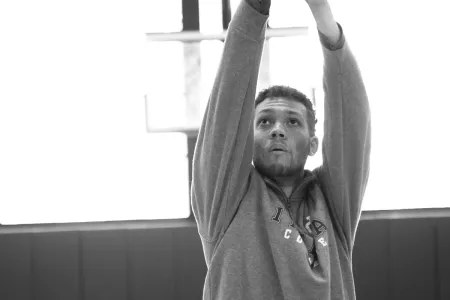 A man shooting a basketball