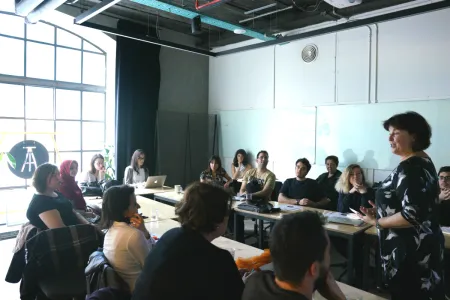 A woman speaking to a group of people