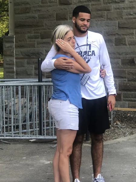 Mother and son embrace