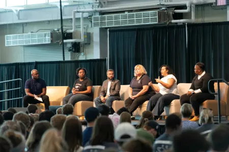 A group of people sitting on a stage
