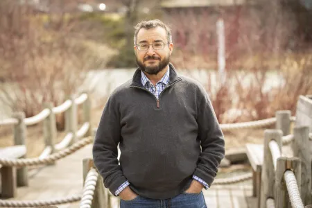 A man standing on a wooden bridge