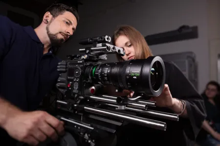 student and staff member setting up RED camera