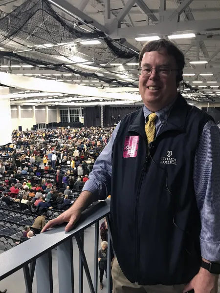 man standing on catwalk of performance venue