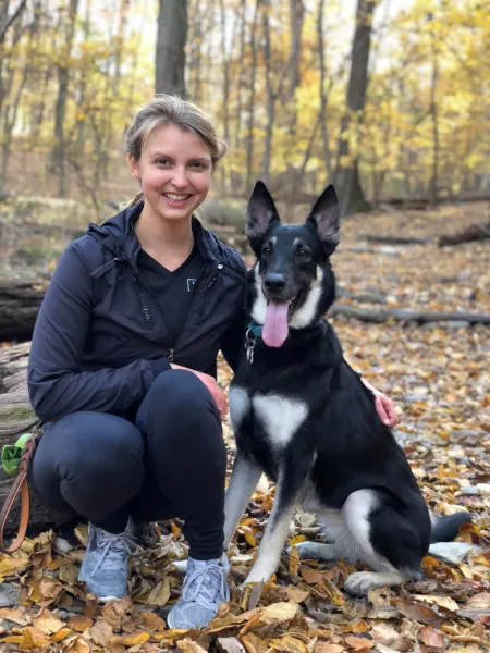 young woman with dog in the woods