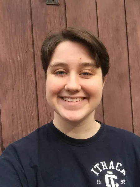 This is a photo of Margaret Callery. Margaret is wearing a blue t-shirt with an Ithaca logo on it. 