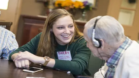 student working with older adult
