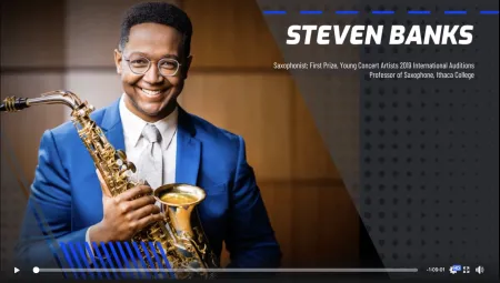 photo of man holding a saxophone