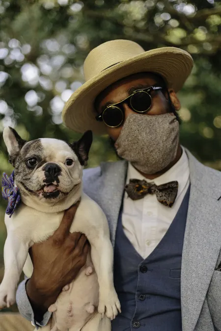 man holding small dog