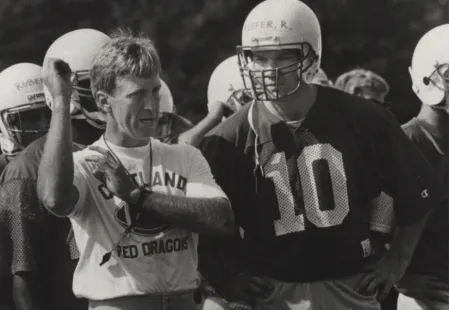football coach demonstrating a throwing motion