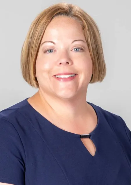 Smiling woman wearing a blue blouse 