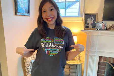 young woman pointing at her blouse 