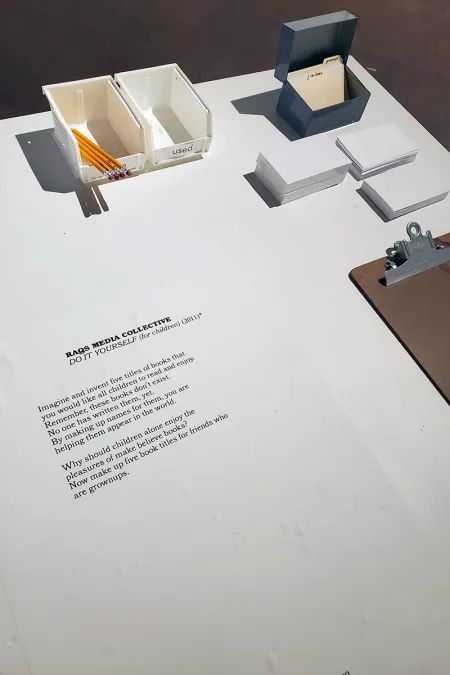 table with written prompt and pencils