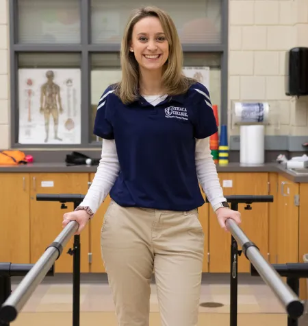 Justina Snyder standing between two bars