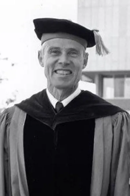 Black and white portrait in academic cap and gown.