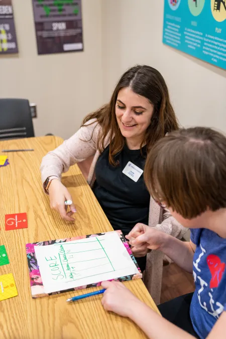 Student clinician supporting client with autism 