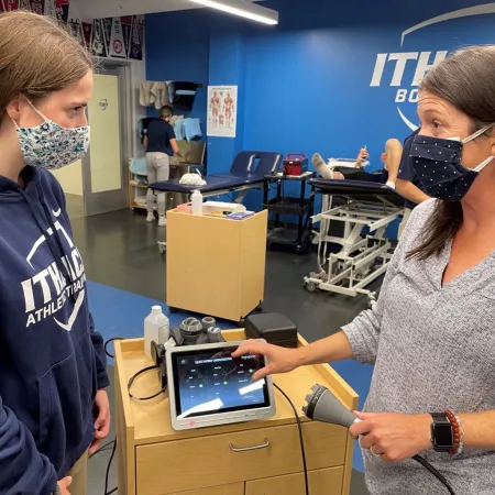 AT working with an AT student in the clinic