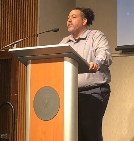 Michael Benitez at a lectern