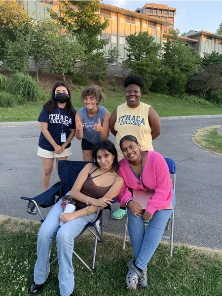 Students sitting and standing outside