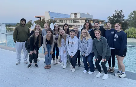 group of students posing in front of the fountains