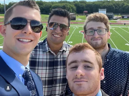 Four park students standing in front of a field
