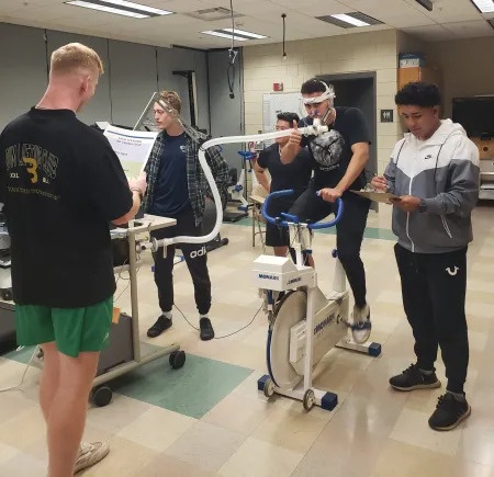 Graduate and undergraduate students conducting a GXT in the Exercise Physiology lab (2023).  