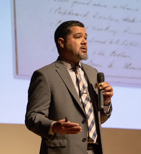 Male Professor Bradwell speaking with a mic
