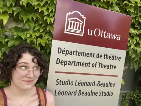 Rachael in front of a sign