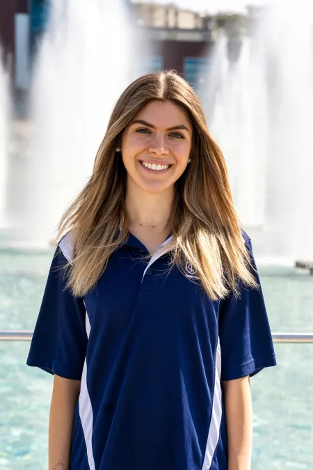 This is a photo of Abigail Hoffert standing in front of the fountains on the Ithaca College campus.