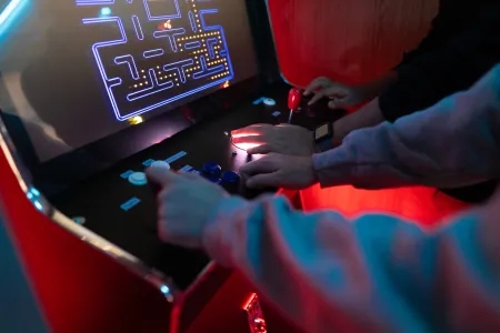 A person plays retro Pac-Man. 