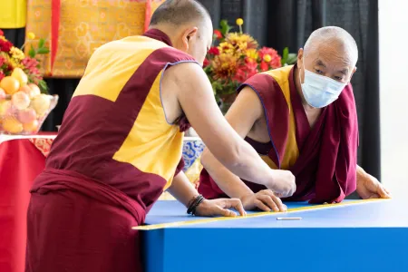Two monks start the outline for the mandala