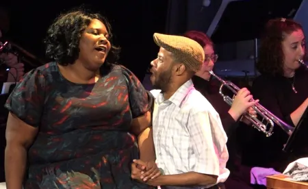 two performers sing to each other 