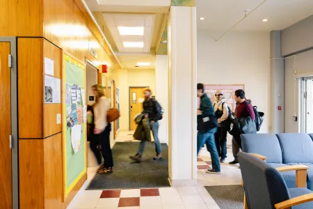 Students enter a residential space after a long day of classes