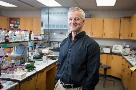 man wearing dark shirt in a laboratory