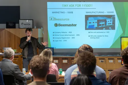 A college student makes a presentation to an audience. 