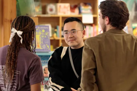 People talk in a bookstore. 