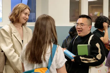 Authors speak with students at a bookstore. 
