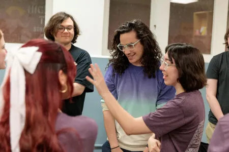 People talk and laugh in a bookstore. 