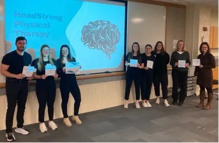 PT students and invited "sharks" stand in front of projection screen