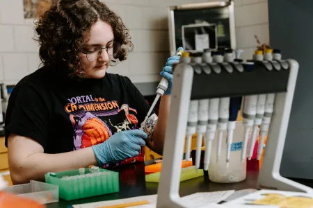 A student works with DNA samples in a lab. 
