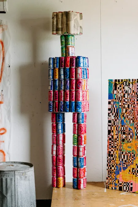 A six-foot-two-inch robot assembled from discarded soda cans. 