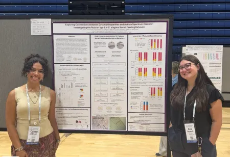 award recipient students alongside their poster