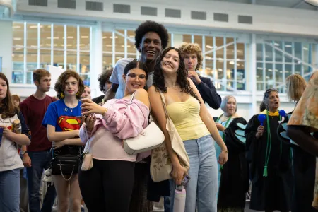 Students embrace for a group photo. 