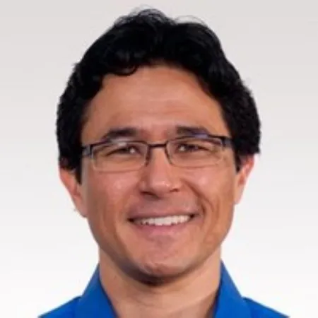 Headshot of Eric Hamako. Eric is wearing a blue collared shirt and glasses.