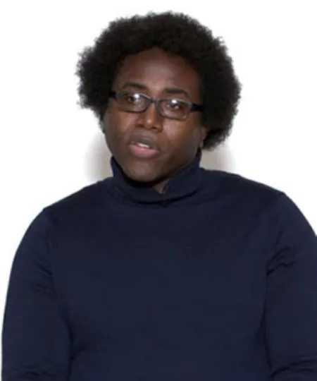 Headshot of Eric Glover. Eric is wearing a navy blue turtleneck sweater and glasses.