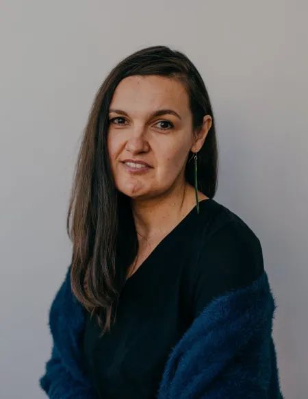 Headshot of Hayley Marama Cavino. Hayley is wearing a sweater with two layered blue pattern.